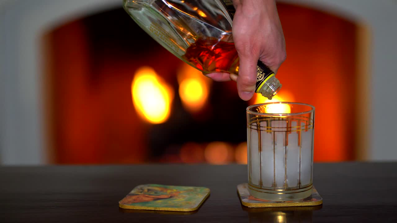 Man with glass in fireplace