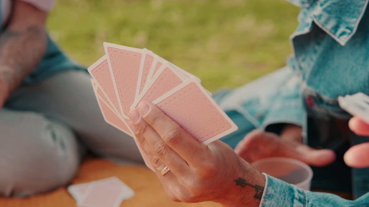 Friends Playing Cards at a Picnic