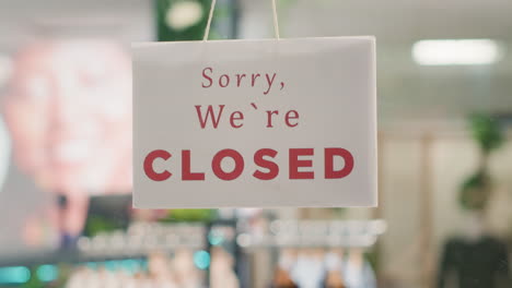 closed sign on clothing store door