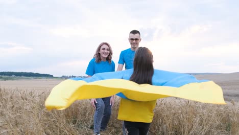 ukrainian family smiling daughter runs and hugs mom and dad ukrainian family smiling daughter runs and hugs mom and dad emotional scene peace in ukraine the future generation parenthood childhood the concept of ukraine