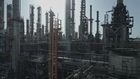 Aerial-footage-of-a-large-scale-Oil-refinery-with-smoke-stacks-and-petroleum-storage-tanks