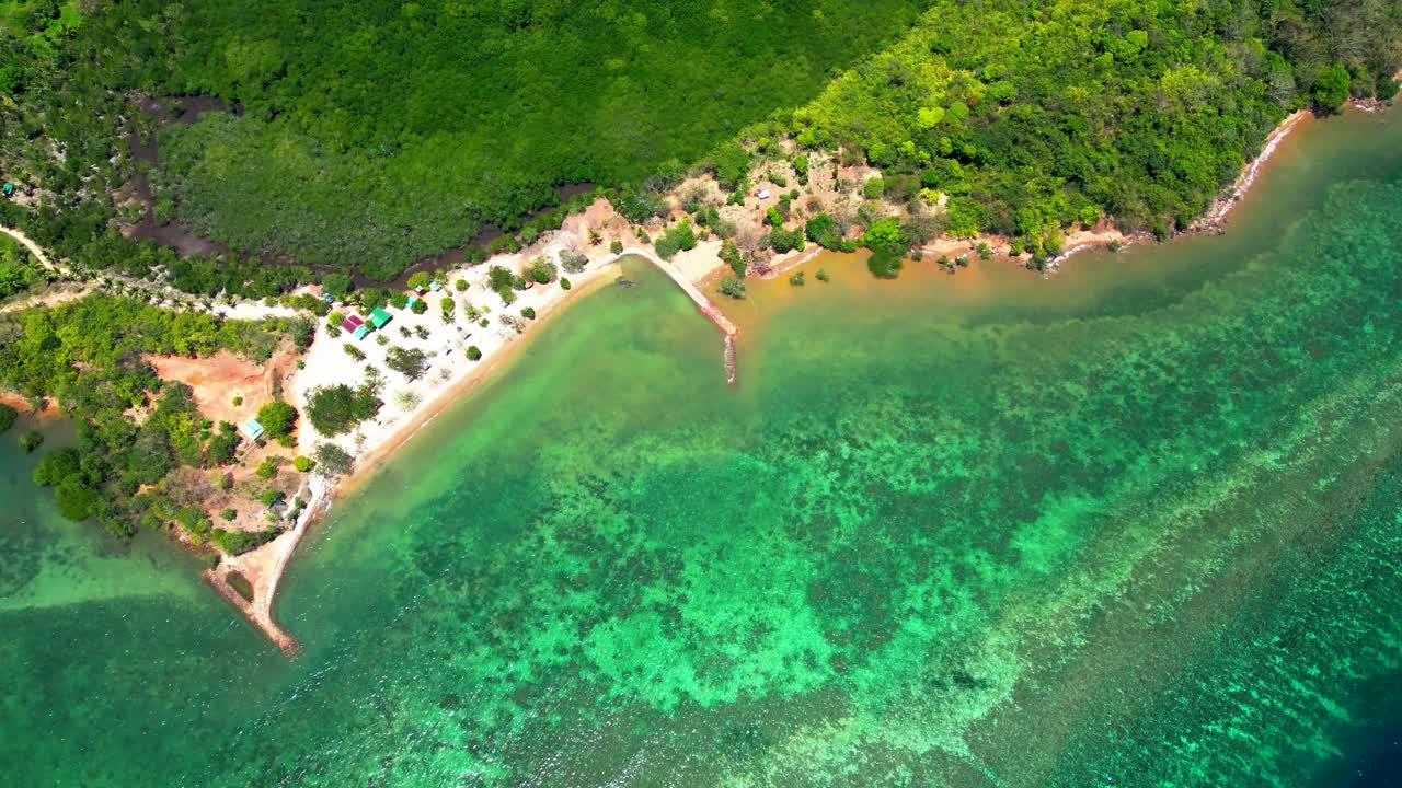 Aerial View of a Tropical Island Coastline with Clear Turquoise Water and Lush Forest