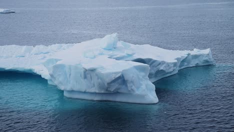 Blue-Iceberg-Floating-Close-Up-in-Ocean,-Antarctica-Icebergs-and-Ice-in-Antarctic-Peninsula-Ocean-Water-with-Beautiful-Shapes-and-Patterns-in-Winter-Seascape,-Iceberg-Detail-in-Icy-Winter-Scene