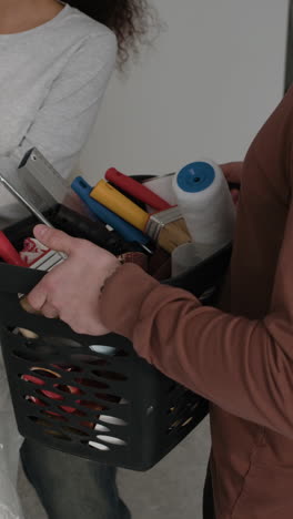 couple preparing painting tools for home renovation