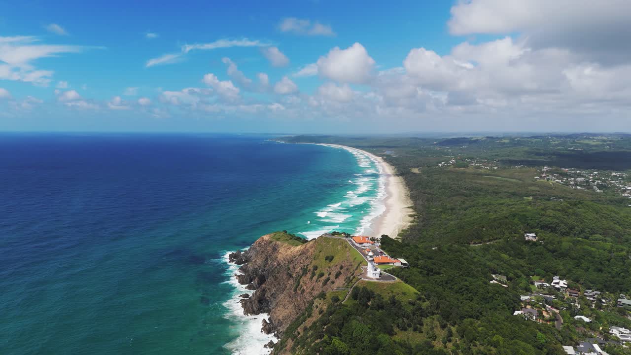 Byron Lighthouse at Byron Bay cape. Aerial dolly out