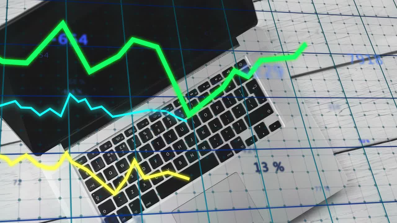On startup silver laptop with grid overlay, graphs animating upward updating labels tracking trends