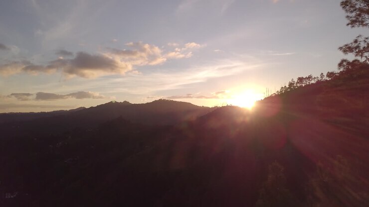Sunset drone footage of a mountains and trees in Valle de Angeles in Honduras