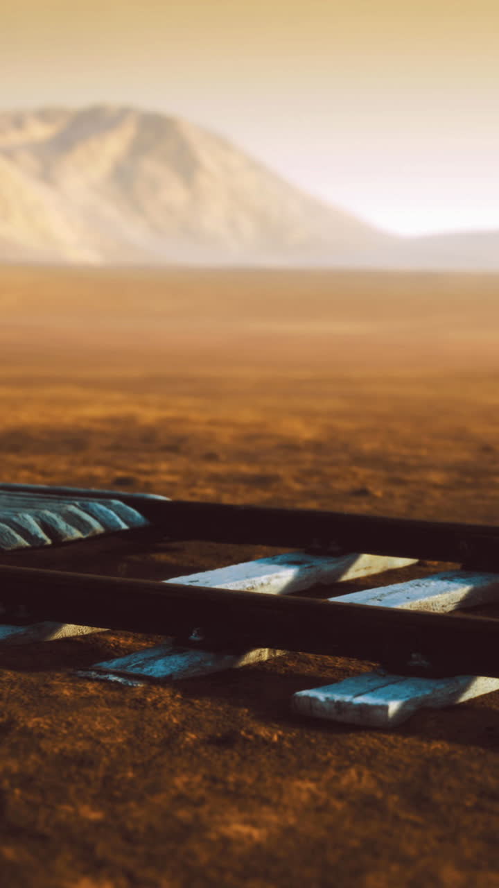 Exploring an abandoned railway track in a remote desert landscape at sunset