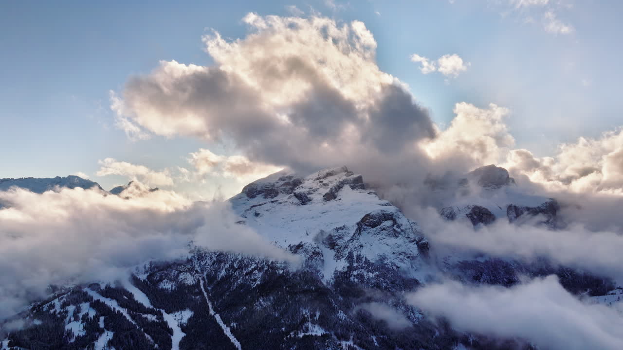 Aerial drone view of the Gardena Pass high mountain pass in the clouds, in the Dolomites, Italy