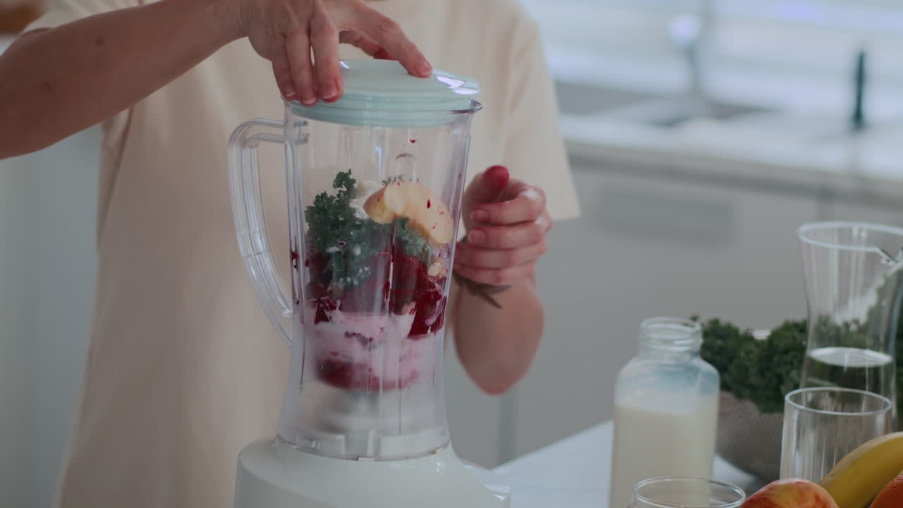 Female Healthy Lifestyle Practitioner Making Fruit Smoothie