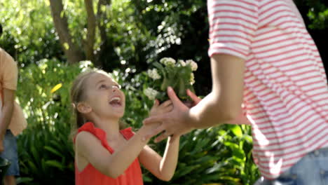 happy daughter running to give flower to her mother