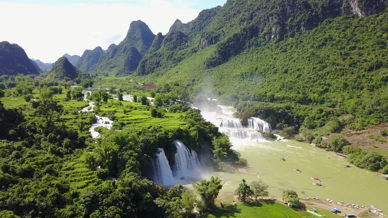 Stunning view of cascading Ban Gioc Waterfalls under bright blue sky