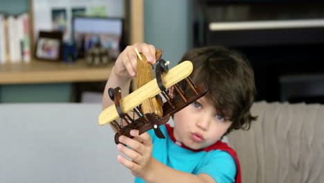 boy playing with a toy plane