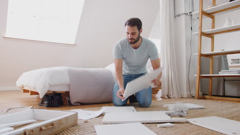 man in new home putting together self assembly furniture