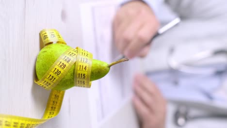 vertical video of nutrition appointmente, pear and measure tape on table