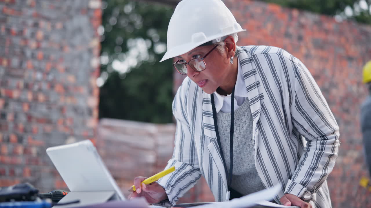 A female engineer wearing a hard hat on a construction site