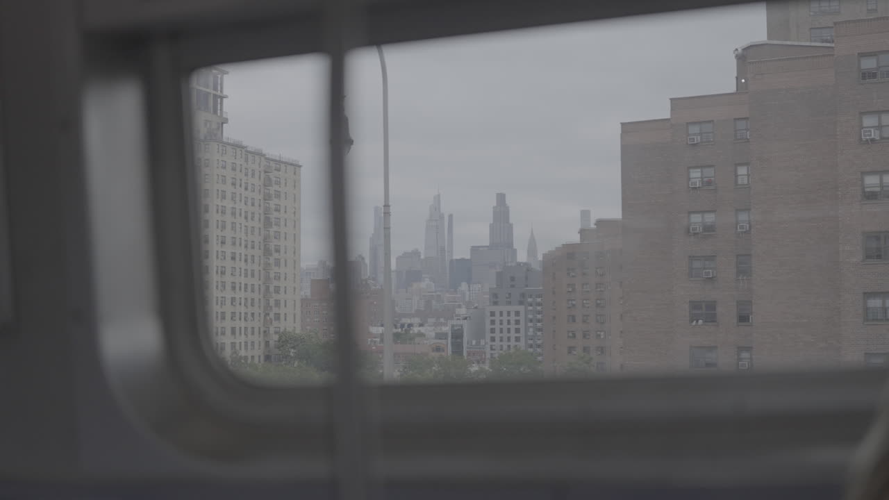 Distant City Skyline and Apartment Buildings from a Moving Window