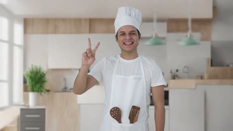 Happy-Indian-professional-chef-showing-victory-sign