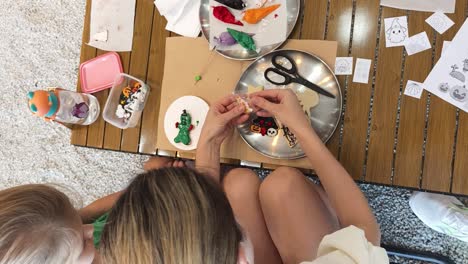 kids and mom decorating halloween cookies