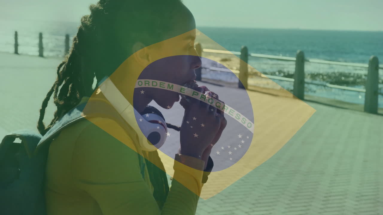 Walking along seaside promenade, person with Brazilian flag overlay animation