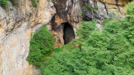 4K-Drone-Video-of-Mountainside-Cave-at-Emerald-Village-near-Little-Switzerland,-NC-on-Summer-Day