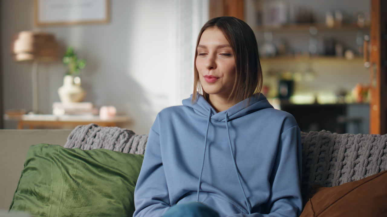 Woman sitting on a couch indoors