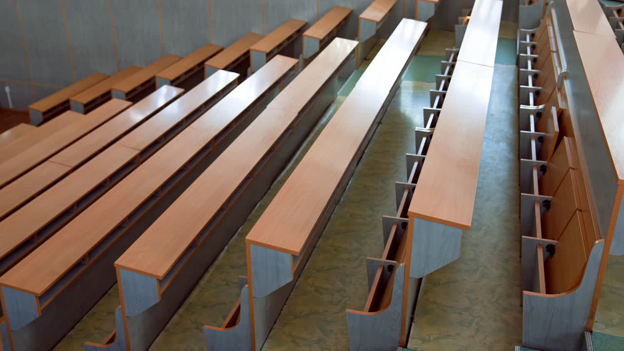 Empty classroom in university. Shot of university classroom with rows of chairs and desks