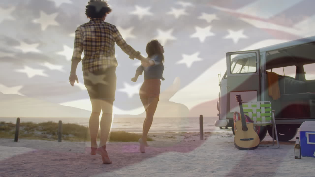 Animation of waving flag of usa over couple having fun on the beach
