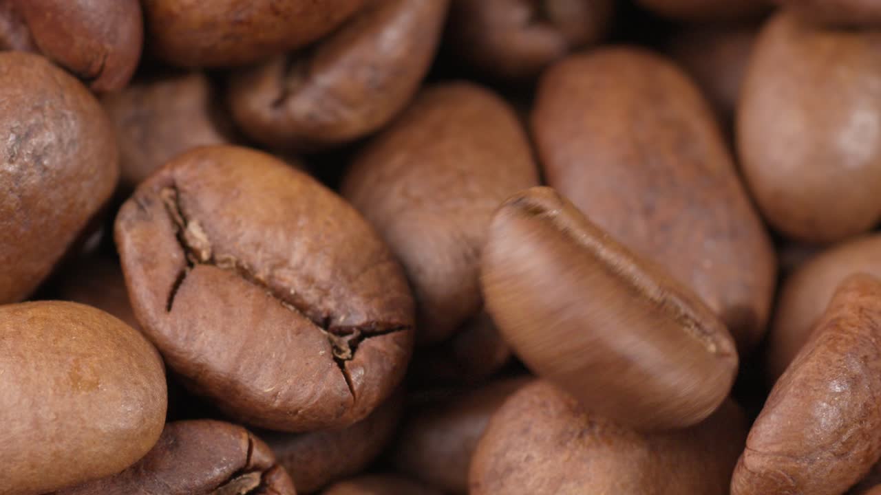 Close up of roasted coffee beans with rich texture, brown tones, and natural lighting, backdrop