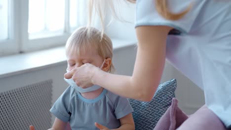 mother putting a mask on a child