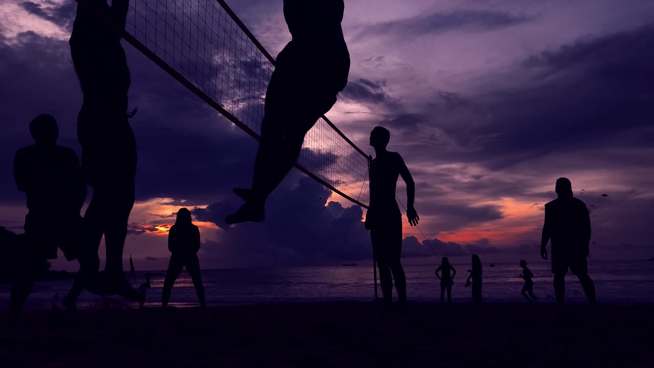 Silhouetted Volleyball Game at Sunset on the Beach