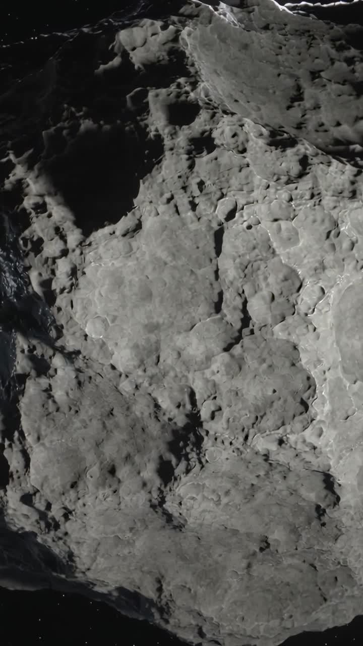 Video verticale: Sonda in orbita che rivela un grande cratere e un bordo illuminato su un asteroide durante un passaggio di rilevamento
