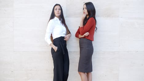 two businesswomen standing chatting outdoors