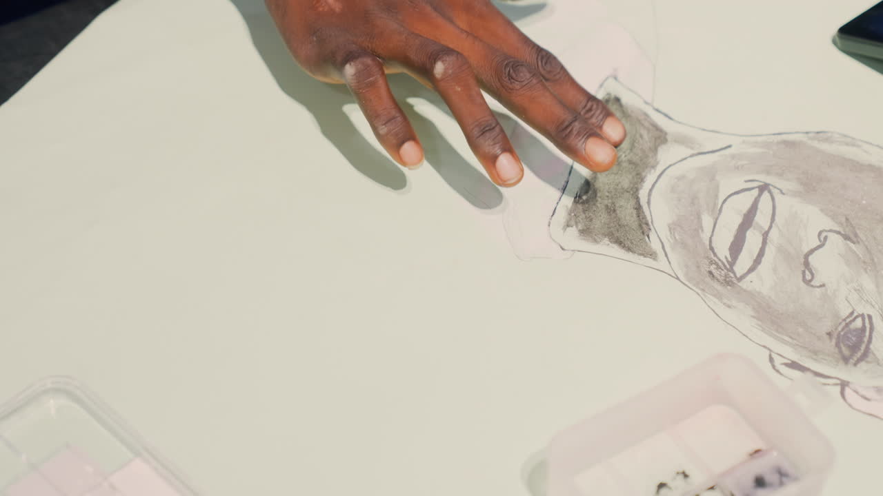 Creating gentle textures through finger smudges. Handcrafted portrait with delicate shading techniques using fingers. Artist applies finger smudging to produce soft tonal effects on paper