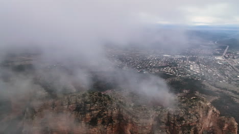 Misty-Clouds-Reveal-Red-Rock-Buttes-Near-Sedona,-Arizona,-United-States