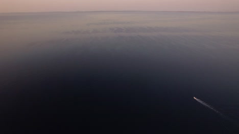 vast water surface with sailing motor boat