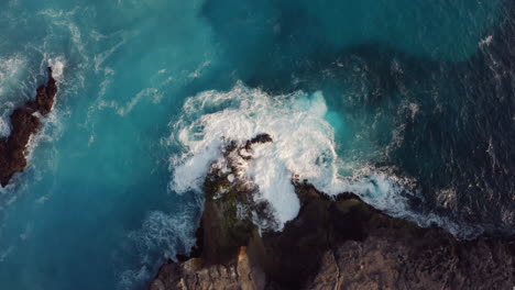 aerial view of ocean waves breaking on rocks beautiful blue sea splashing on shoreline coastal surf 4k