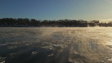 a tranquil icy winter morning scene featuring a foggy sunrise over the frozen lake, north america, quebec, montreal, canada.