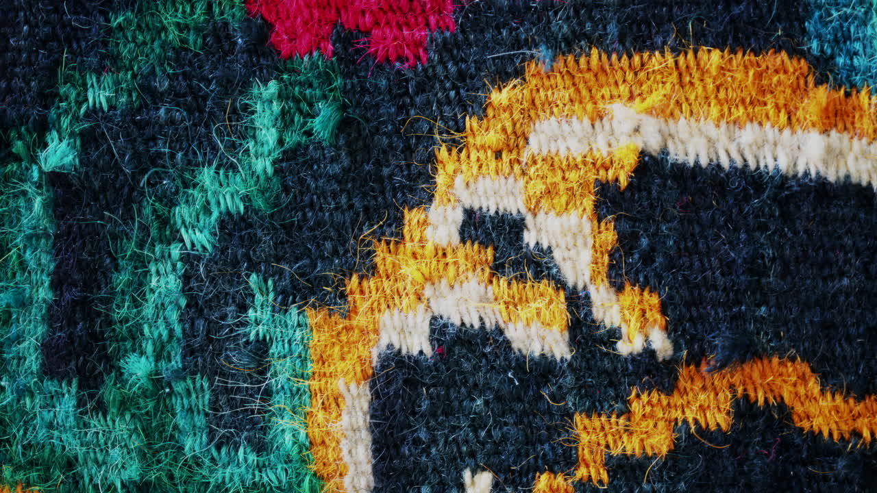 Close up of a traditional floral carpet with vivid colors and intricate woven details