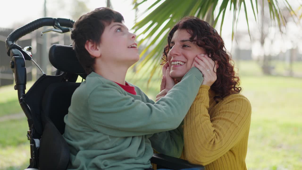 A mother and her child with a disability share a tender moment outdoors