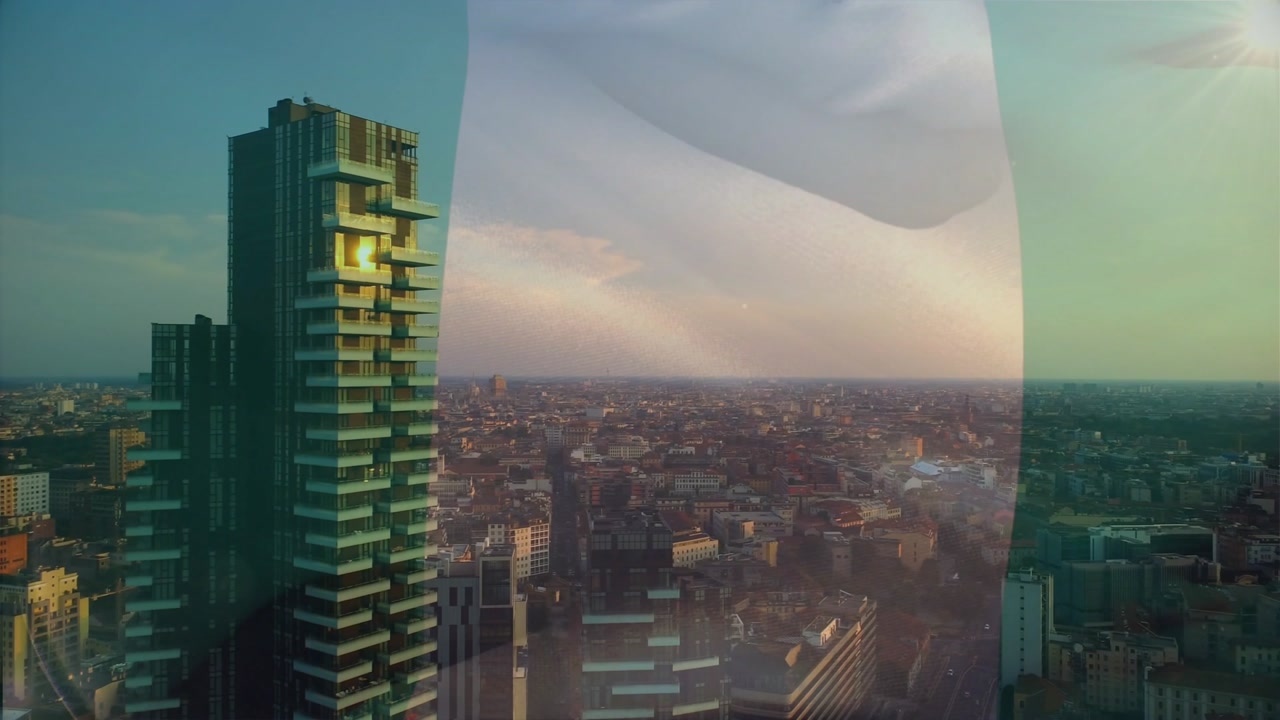Tri-color flag drifting from top, tower staying still while camera shifting left to reveal skyline