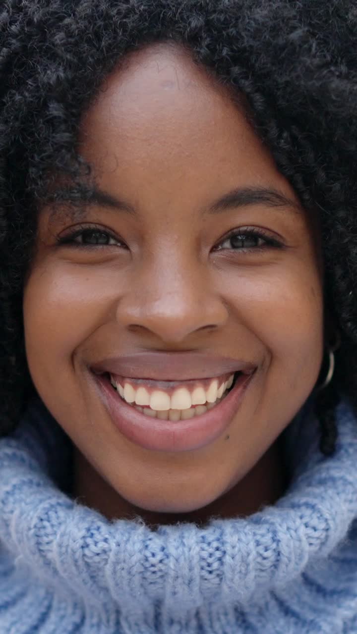 Beauty african young woman smiling at camera outdoors