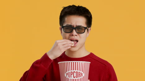 man eating popcorn with 3d glasses