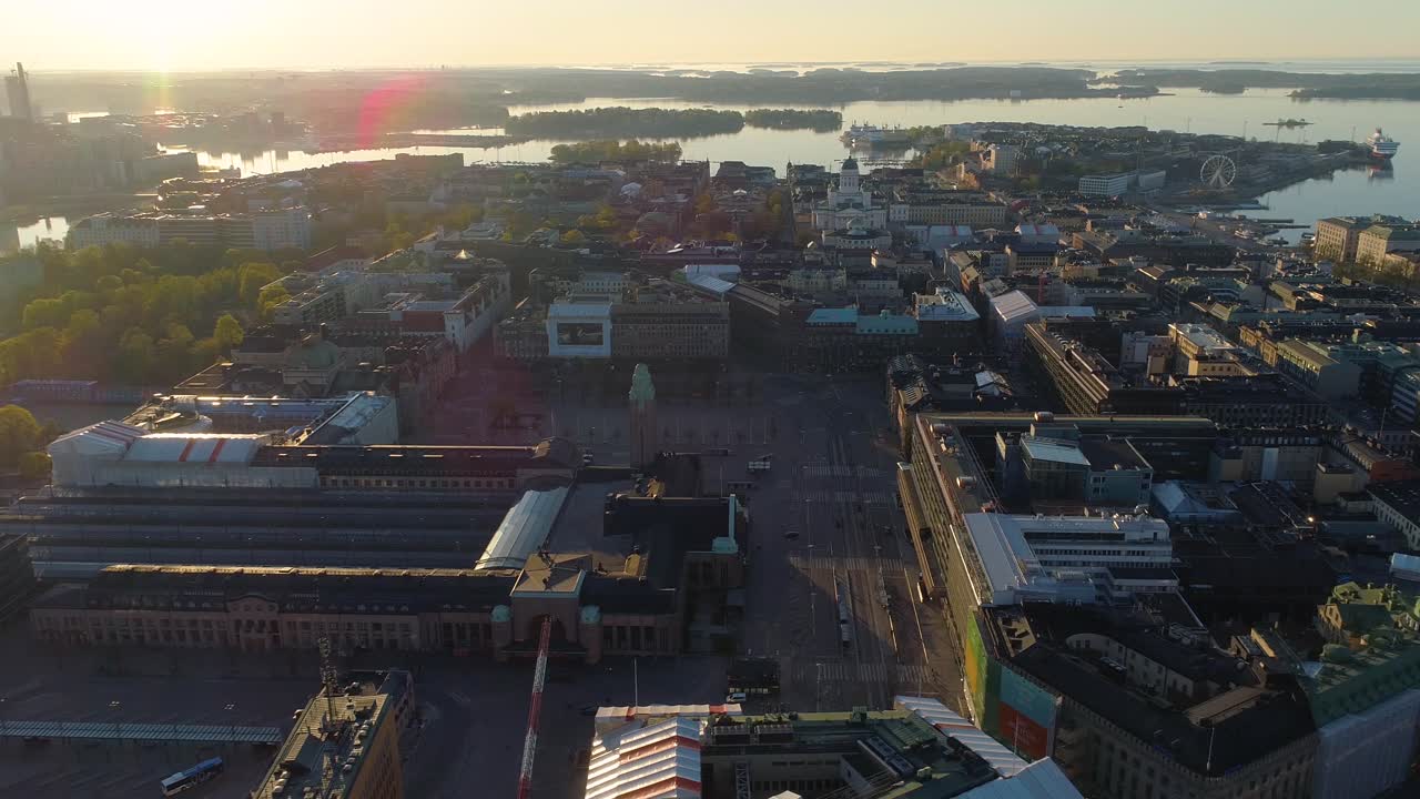 Aerial view around the Helsinki Central Railway station on a sunny, summer morning, sunrise, in Downtown Helsingfors, Finland- orbit, drone shot