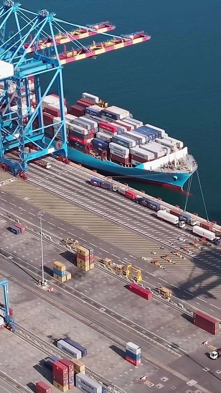 Busy port scene in Accra with containers and cranes at work