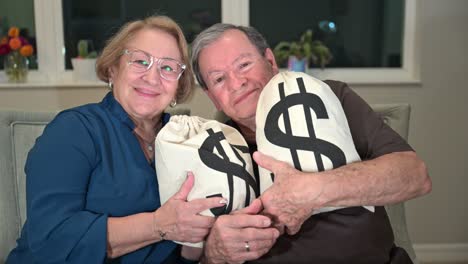 proud senior citizen lottery winners cuddle bags of cash in their retirement years