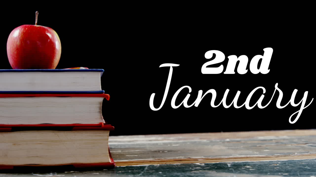 Animazione del testo '2 gennaio' su libri e mela su sfondo nero