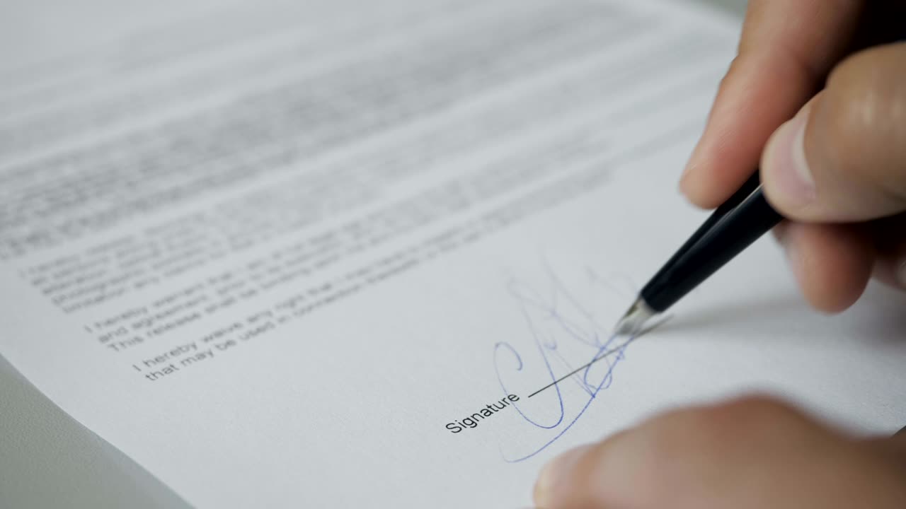 Notary public in office stamping document. Businessman stamping document table, director approving contract, paperwork. Man is approve documents by signing and stamping papers. Closeup. UHD 4K.