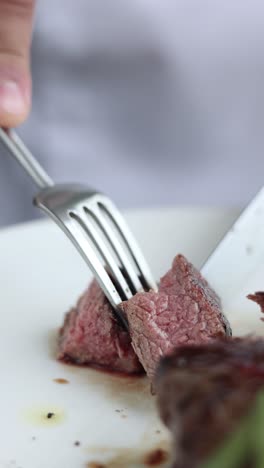 chef cutting a steak