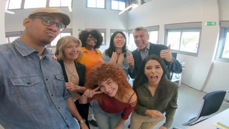 happy coworkers taking a selfie in the office